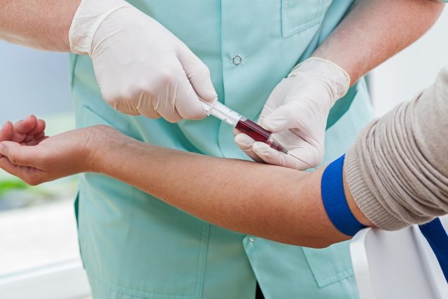 Nurse collecting a blood from a patient