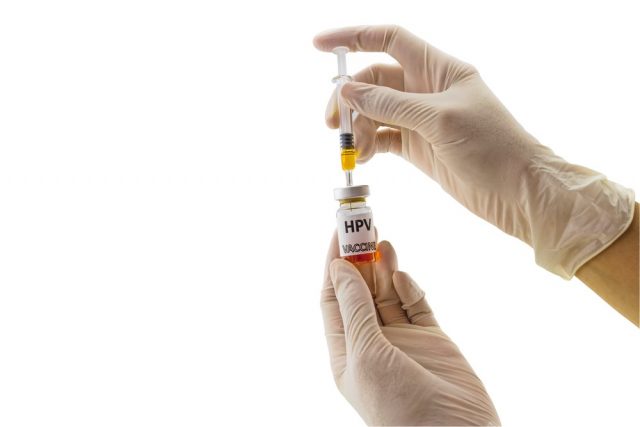 Hands of the doctor filling a vaccine syringe and bottle vaccine of Human papillomavirus (HPV) vaccine