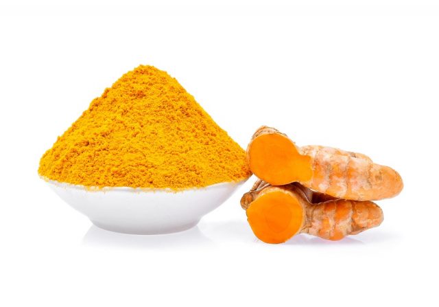 Turmeric roots with turmeric powder