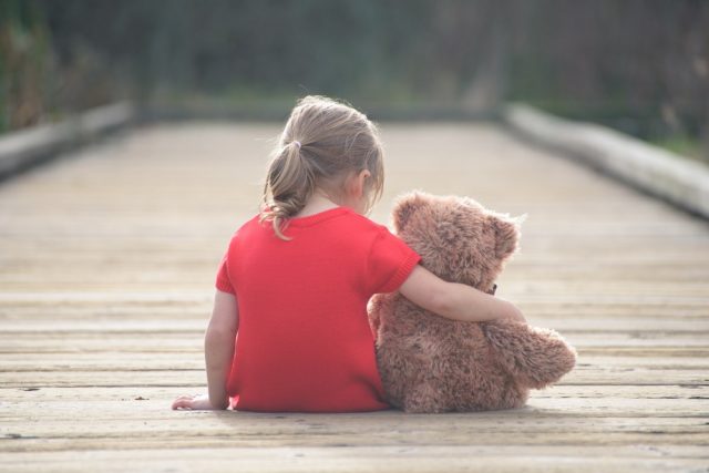  small sad girl with teddybear