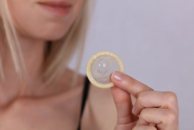 Woman holding condom