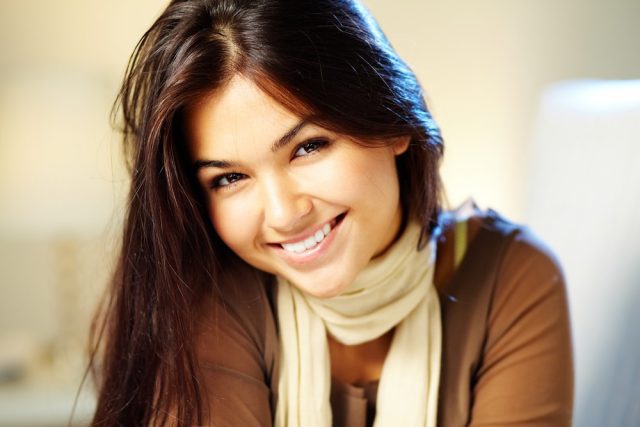  young woman with dark hair smiling at camera