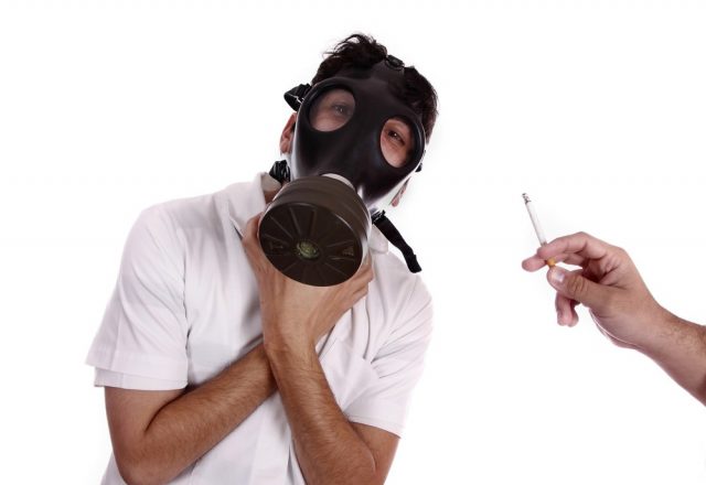 Man wearing a gas mask, trying to avoid pollution