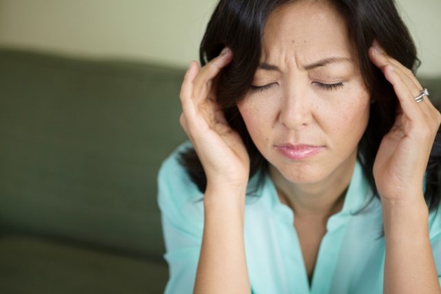 Premenopause: Woman with a headache