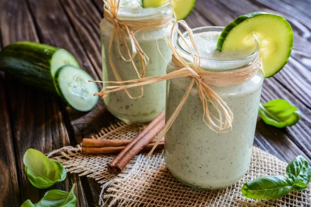 Organic cucumber smoothie with basil, yogurt and cinnamon in a glass jar