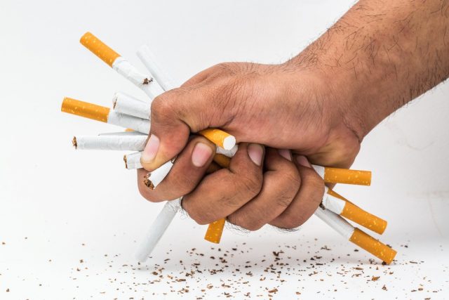 Quit smoking.Close up hand destroying some cigarettes