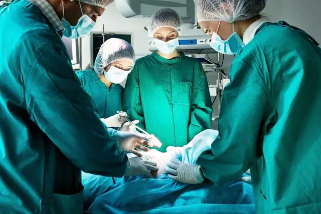 Surgery team operating in a surgical room