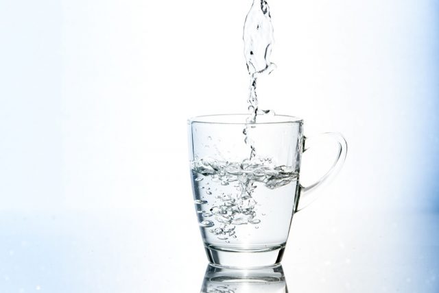 Blue tone of Pouring water in glass