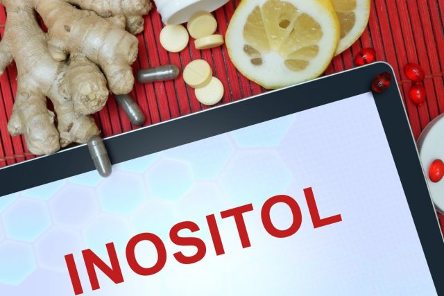 Tablet with words Inositol, pills, lemon and ginger. Healthy eating.