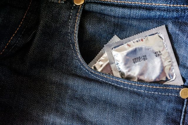 Condoms in package in jeans