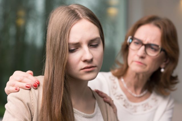 Persistent Depressive Disorder: Supportive mother helping her worried teenage daughter