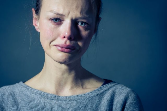 Persistent Depressive Disorder: Young woman suffering from severe depression/anxiety/sadness, crying, tears coming from her eyes