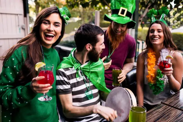 Friends celebrating St Patricks day with drinks in a bar