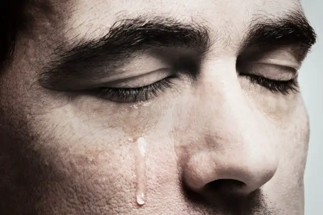 Crying man with tears on face