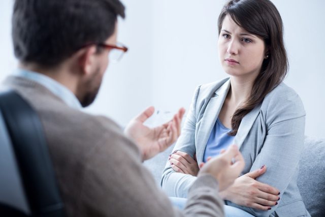 Young scared woman with mental problem on psychotherapy