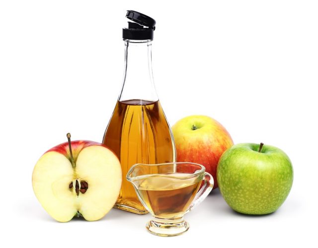  full bottle and cup of Apple cider vinegar