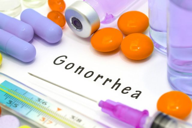 Gonorrhea. Syringe and vaccine with drugs.
